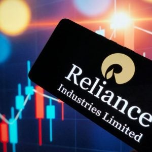 Reliance industries logo on smartphone screen with stock market graph, New York City