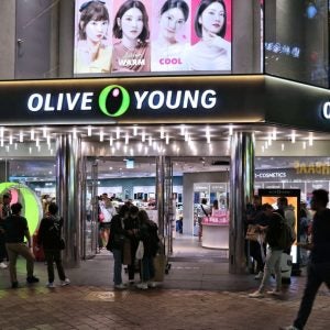 People visit Olive Young Korean beauty store in Myeongdong shopping district in Seoul by night.
