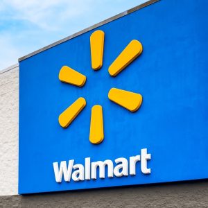 Exterior view of Walmart store logo sign. Founded by Sam Walton in 1962, Walmart operates a chain of discount retail and grocery stores