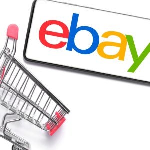 Smartphone with ebay logo,shopping basket white background.Concept online shopping